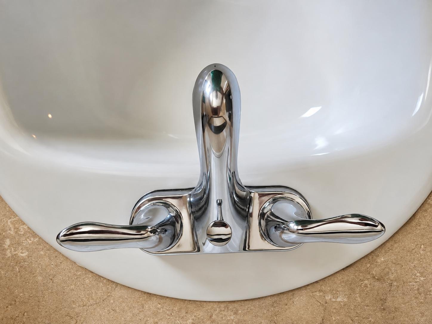 Chrome bathroom faucet polished after cleaning